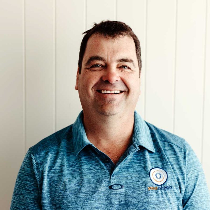Iain McLean, physiotherapist and founder of Your Physio, smiling in a Your Physio polo shirt