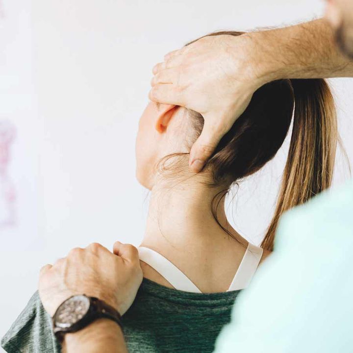 Physiotherapist assessing a patient's neck and head position